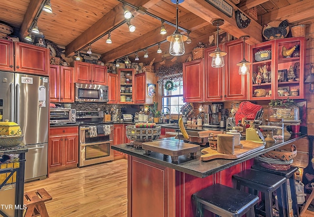 kitchen with wood ceiling, light hardwood / wood-style flooring, appliances with stainless steel finishes, pendant lighting, and beam ceiling