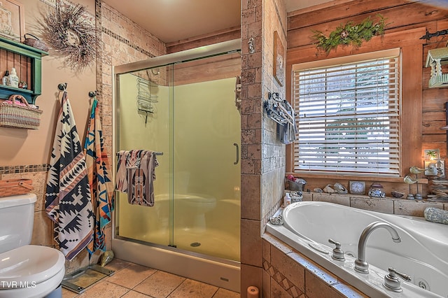 bathroom featuring toilet, separate shower and tub, and tile patterned flooring