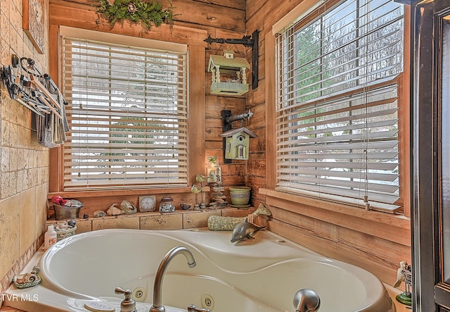 bathroom featuring plenty of natural light and a bathing tub