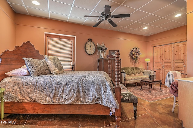 bedroom with a drop ceiling and ceiling fan