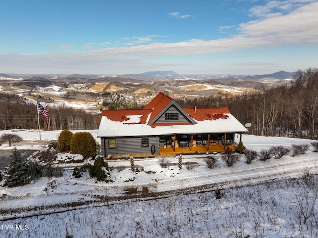 view of front facade featuring a mountain view and covered porch