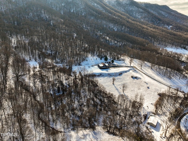 snowy aerial view with a mountain view