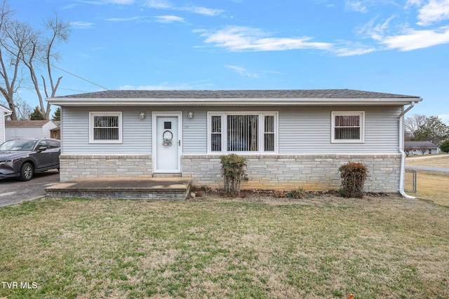 ranch-style home featuring a front yard