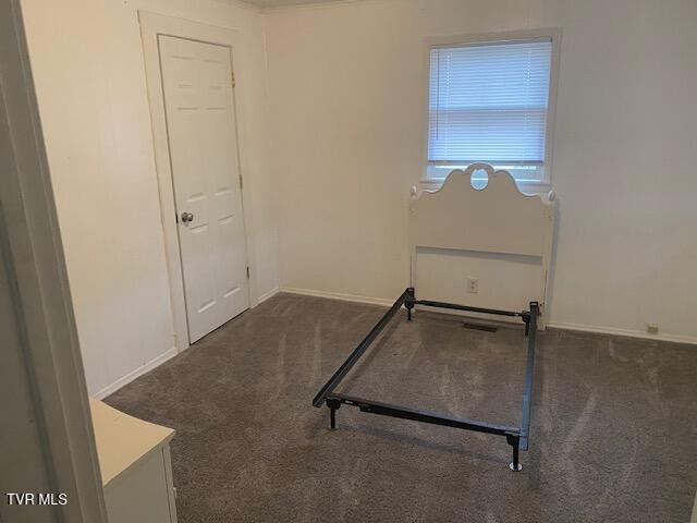 unfurnished bedroom with carpet flooring and baseboards