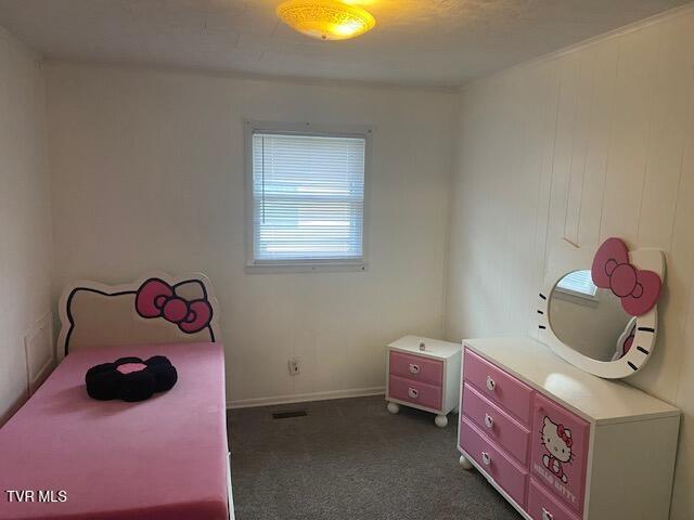 bedroom featuring baseboards and dark colored carpet