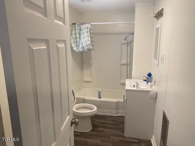 full bathroom with visible vents, toilet, wood finished floors, vanity, and shower / bathing tub combination