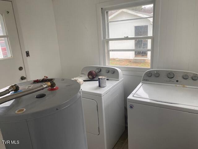 laundry area with laundry area, independent washer and dryer, and a sink