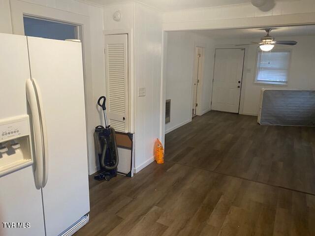 kitchen featuring white refrigerator with ice dispenser, ceiling fan, and wood finished floors