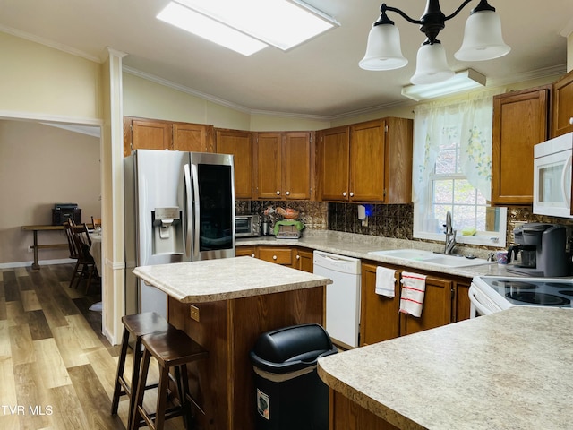 800 Buffalo Ridge Rd, Big Stone Gap, VA 24219 - kitchen featuring sink, crown molding, white appliances, hanging light fixtures, and a kitchen breakfast bar