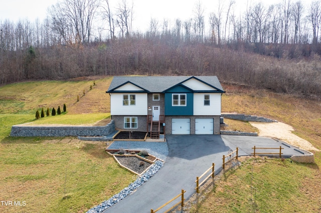 view of front of house featuring a garage and a front yard