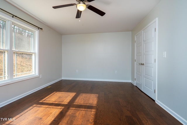 spare room featuring dark hardwood / wood-style floors and ceiling fan
