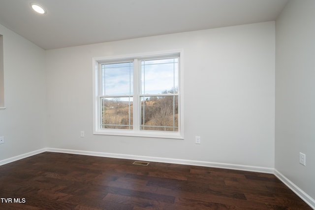 empty room featuring dark hardwood / wood-style flooring