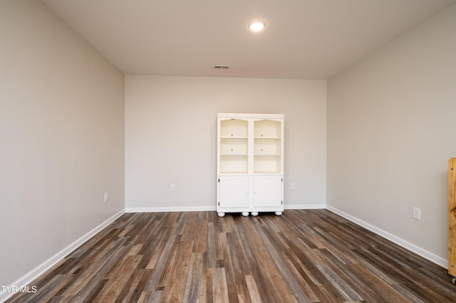 unfurnished bedroom with dark wood-type flooring