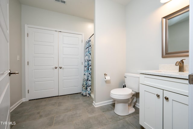 bathroom featuring vanity, toilet, and a shower with shower curtain