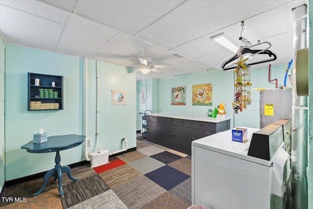 washroom with water heater, washer / dryer, and ceiling fan