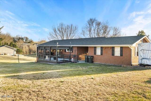 back of property featuring a lawn and a patio area