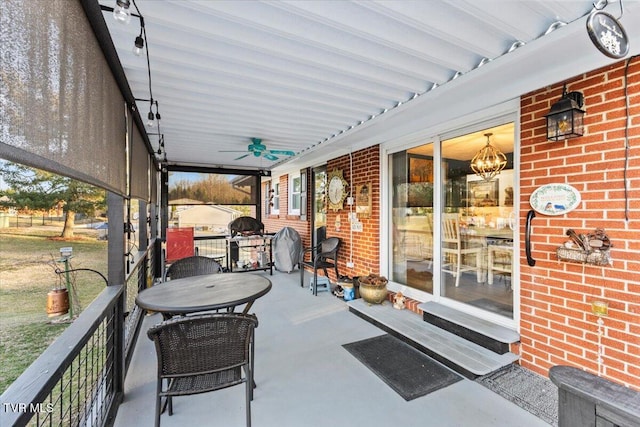 sunroom featuring ceiling fan