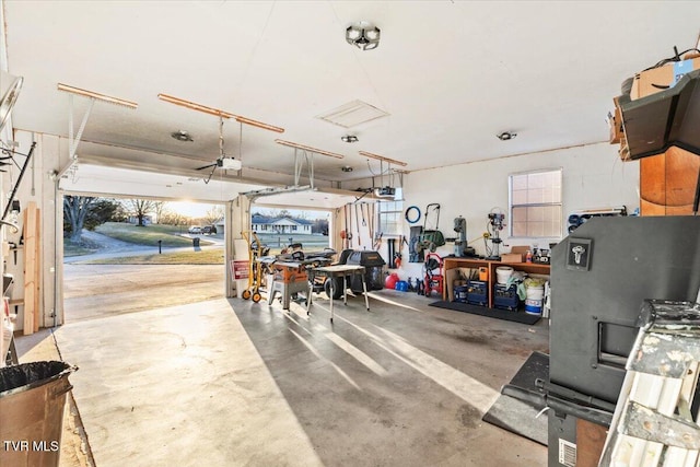 garage with a garage door opener and a workshop area