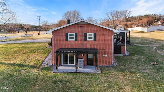 back of house featuring cooling unit, a yard, and a patio area