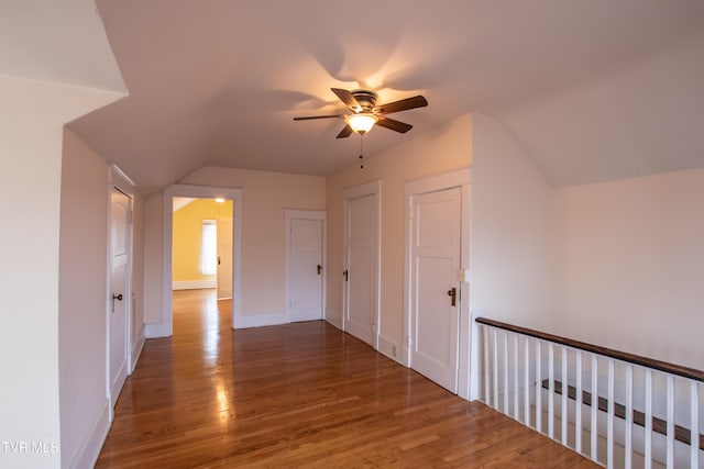 additional living space with lofted ceiling, dark hardwood / wood-style floors, and ceiling fan