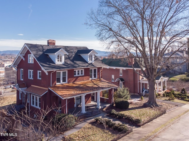 view of front of house with a porch and a mountain view