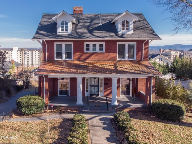 view of front of property with a porch and a mountain view