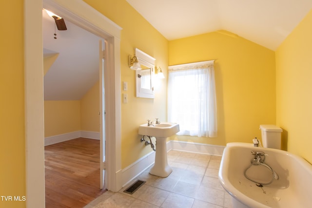 bathroom with tile patterned flooring and lofted ceiling