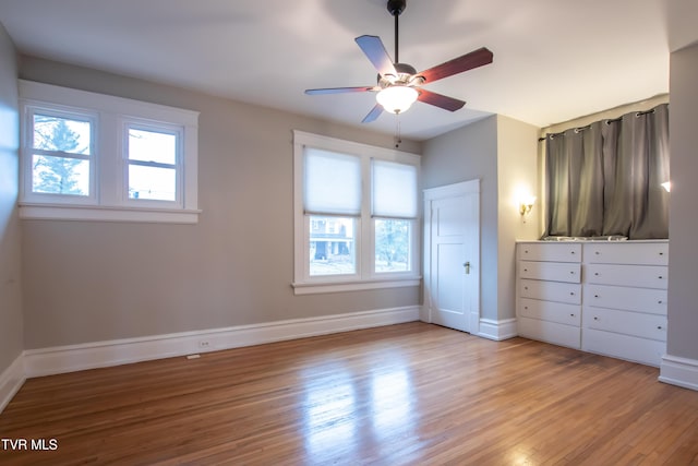 unfurnished bedroom with ceiling fan and light wood-type flooring