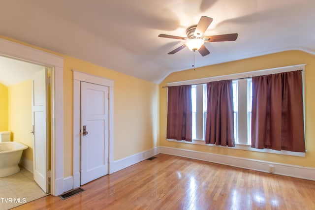 unfurnished room featuring lofted ceiling, ceiling fan, and light wood-type flooring