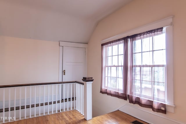 stairs featuring vaulted ceiling and hardwood / wood-style floors