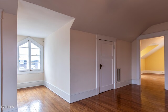 bonus room featuring wood-type flooring and vaulted ceiling