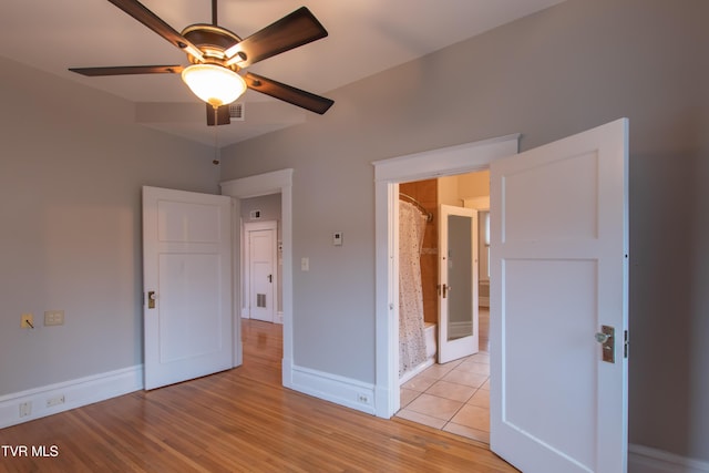 unfurnished bedroom featuring ceiling fan and light hardwood / wood-style flooring