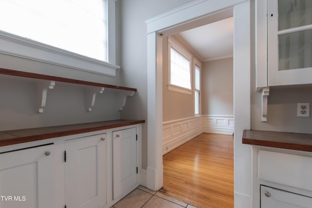 interior space with hardwood / wood-style floors and ornamental molding