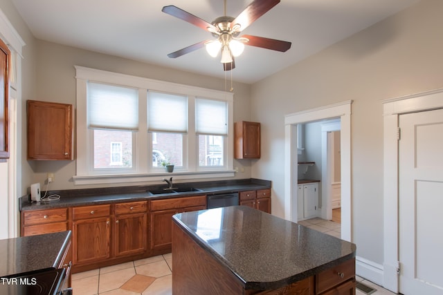 kitchen with sink, a center island, light tile patterned floors, dishwasher, and ceiling fan