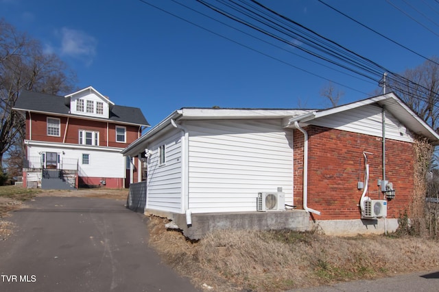 view of side of property with ac unit