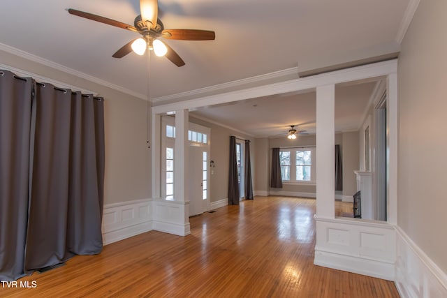 entrance foyer with crown molding, ceiling fan, and light hardwood / wood-style flooring