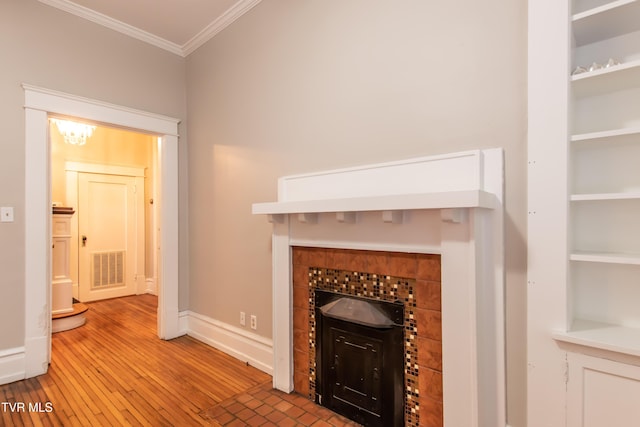 unfurnished living room featuring light hardwood / wood-style flooring and ornamental molding