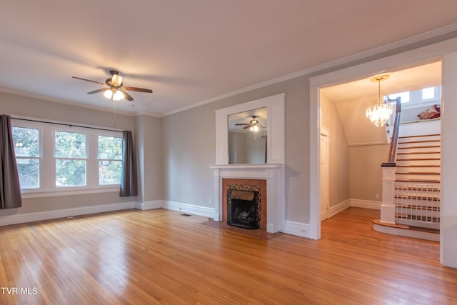 unfurnished living room featuring crown molding, a tile fireplace, and light wood-type flooring