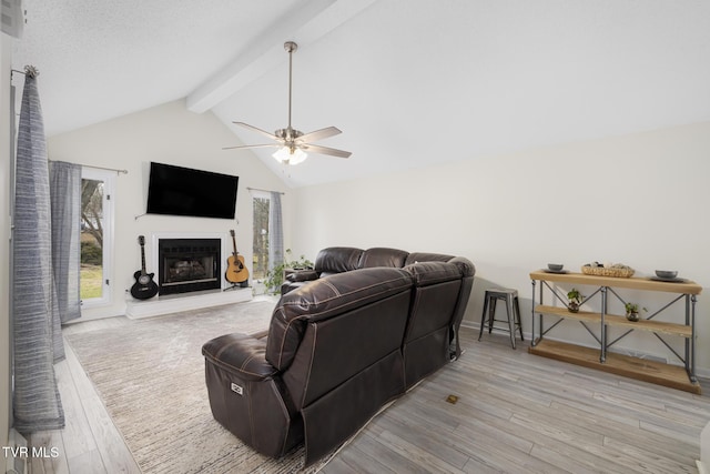 living room featuring ceiling fan, vaulted ceiling with beams, and light wood-type flooring