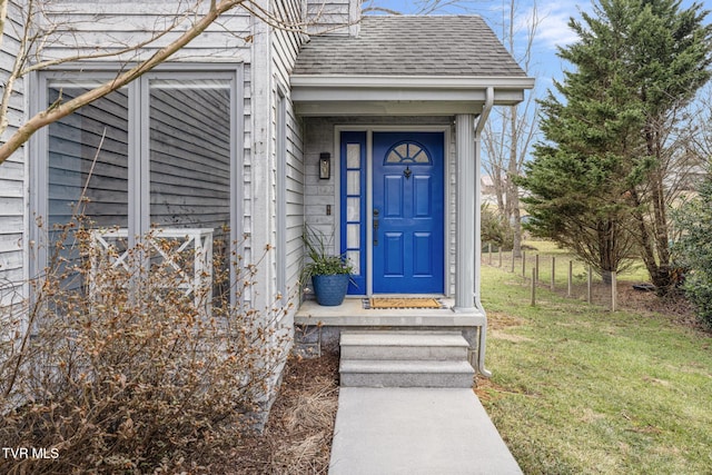 property entrance featuring a lawn