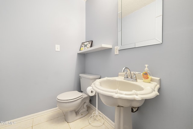 bathroom with tile patterned floors and toilet