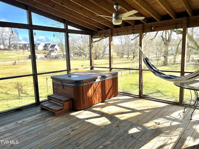 sunroom featuring lofted ceiling and ceiling fan