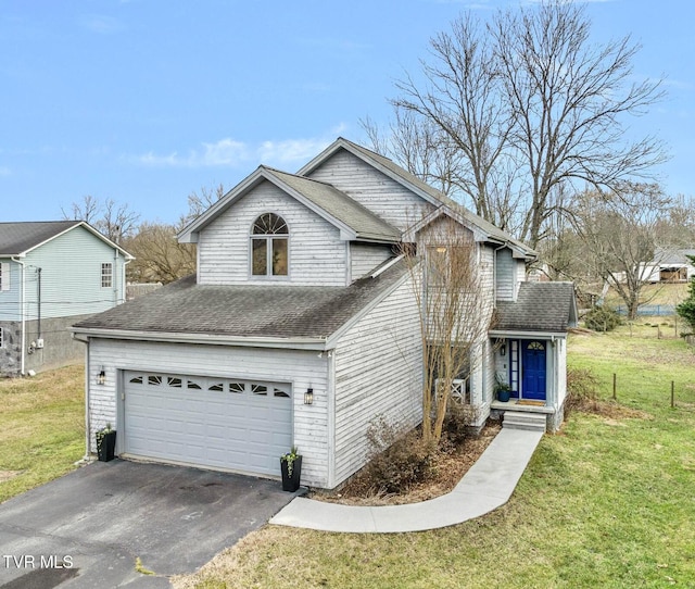 view of front of property featuring a garage and a front lawn