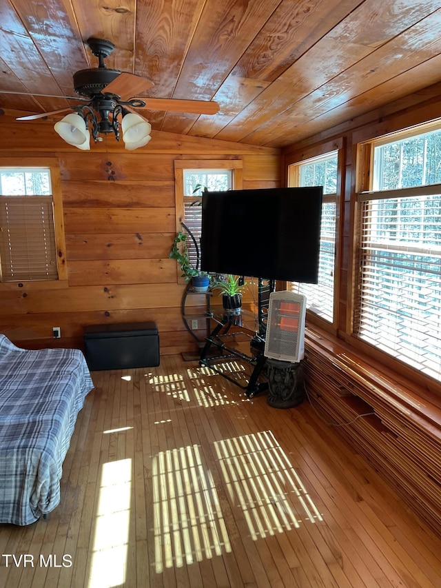 bedroom featuring wood walls, wood finished floors, and wood ceiling