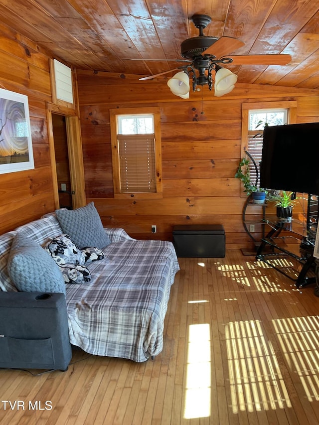 bedroom featuring wood walls, wood ceiling, and wood finished floors