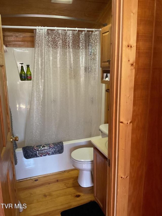 full bathroom featuring toilet, shower / tub combo, wood finished floors, and vanity