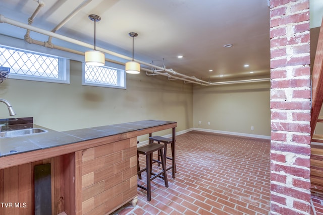 kitchen with decorative light fixtures and sink