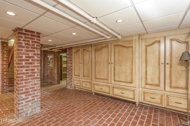 basement with a paneled ceiling