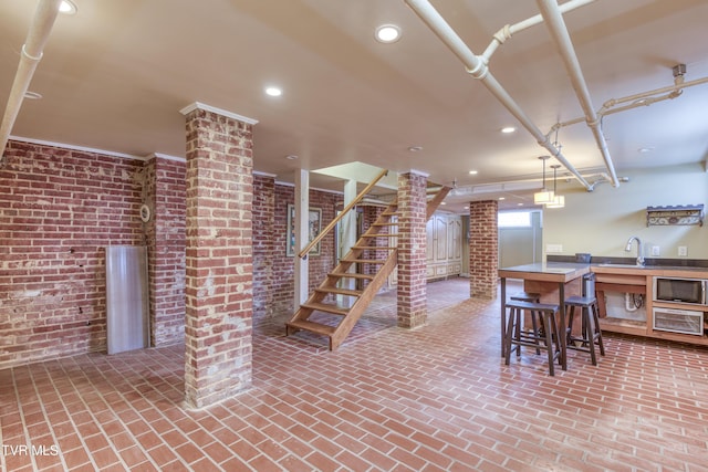 dining room with brick wall and sink