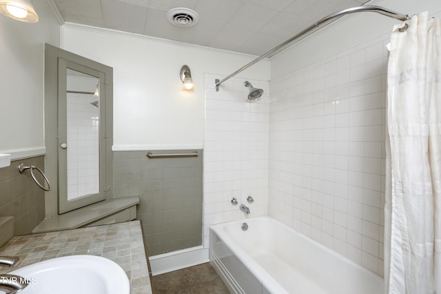 bathroom with tile patterned floors, sink, crown molding, tile walls, and shower / bath combination with curtain